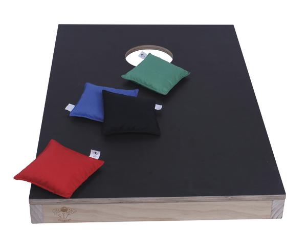Schwarzes Cornhole-Spielbrett mit vier bunten Wurfsäcken in Rot, Blau, Schwarz und Grün.